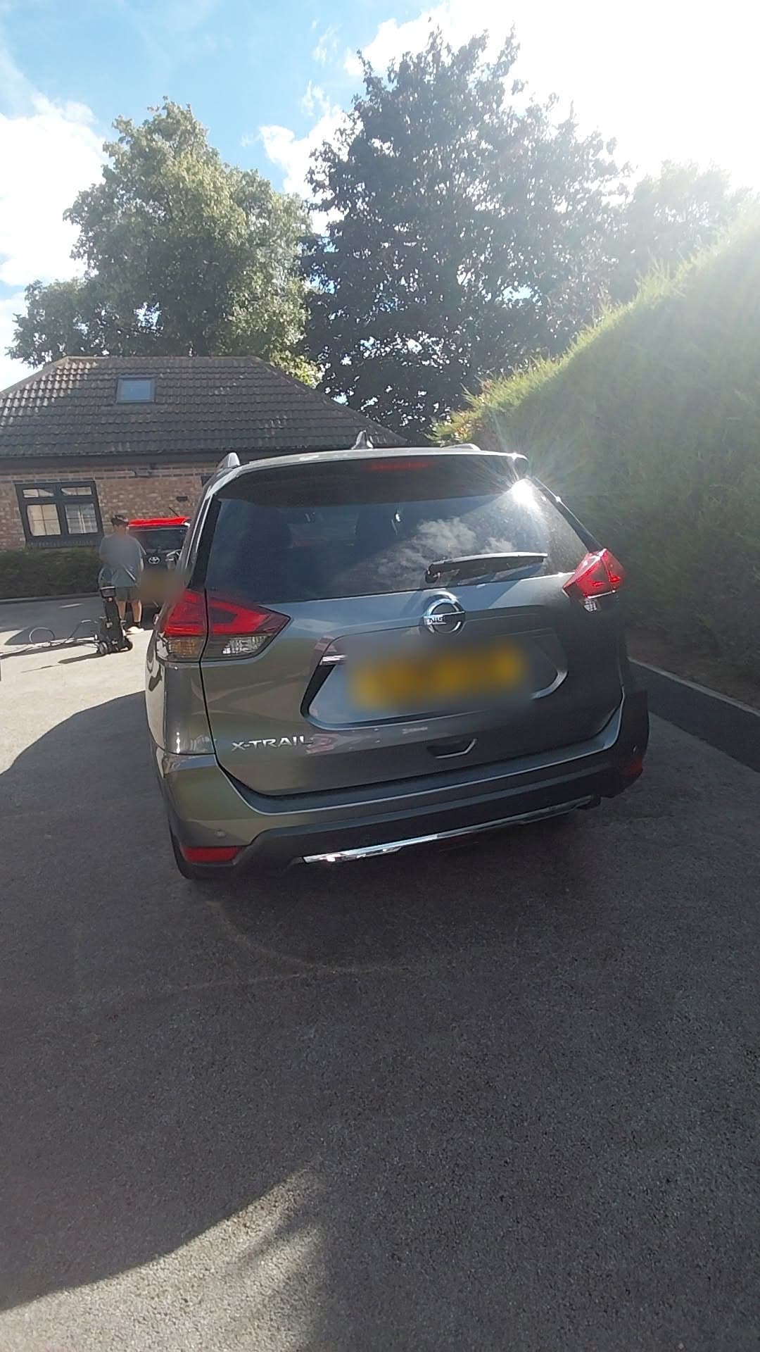 Rear of the Nissan X-Trail on the driveway with the pressure washer set up behind it